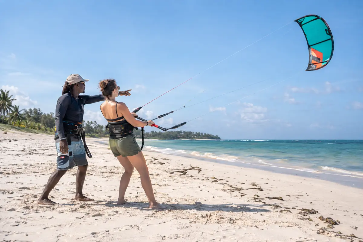Beginner practising kite control with an instructor on Bofa Beach in Kilifi.