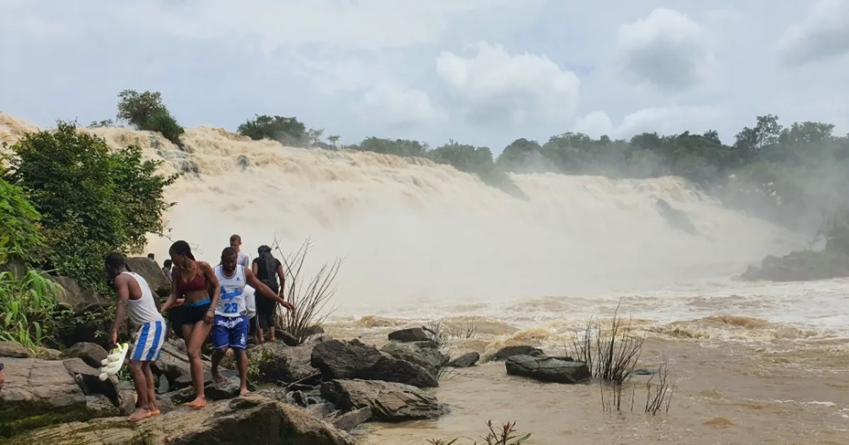 Visitors watching the broad, powerful flow of Gurara Waterfalls during the rainy season in Niger State.