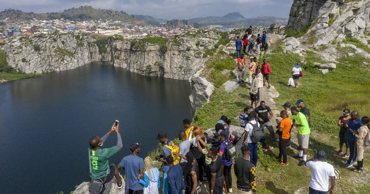 Visitors gathered above the blue-green quarry lake at Mpape Crushed Rock in Abuja.