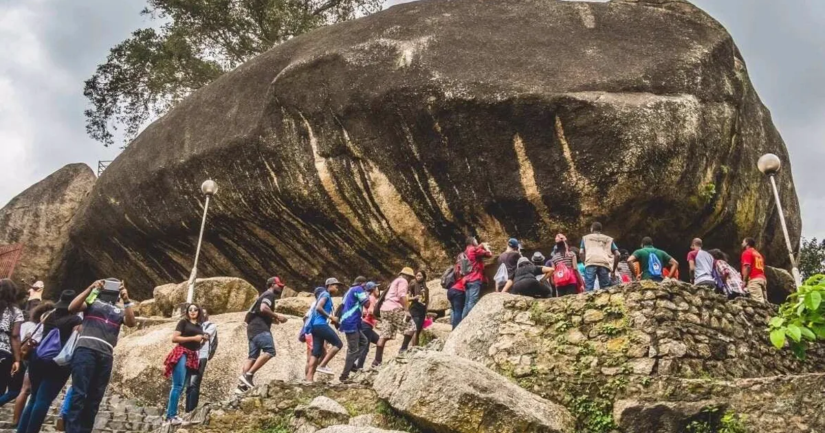 Visitors gathered beneath the massive granite formations while climbing Olumo Rock in Abeokuta.