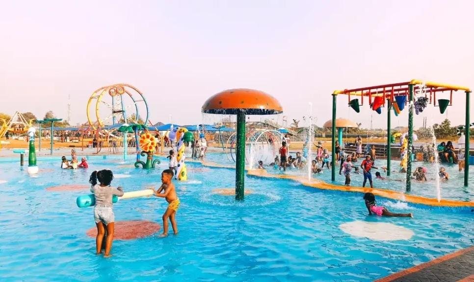 Children enjoying colourful water slides and amusement activities at Omu Resort in Lagos.