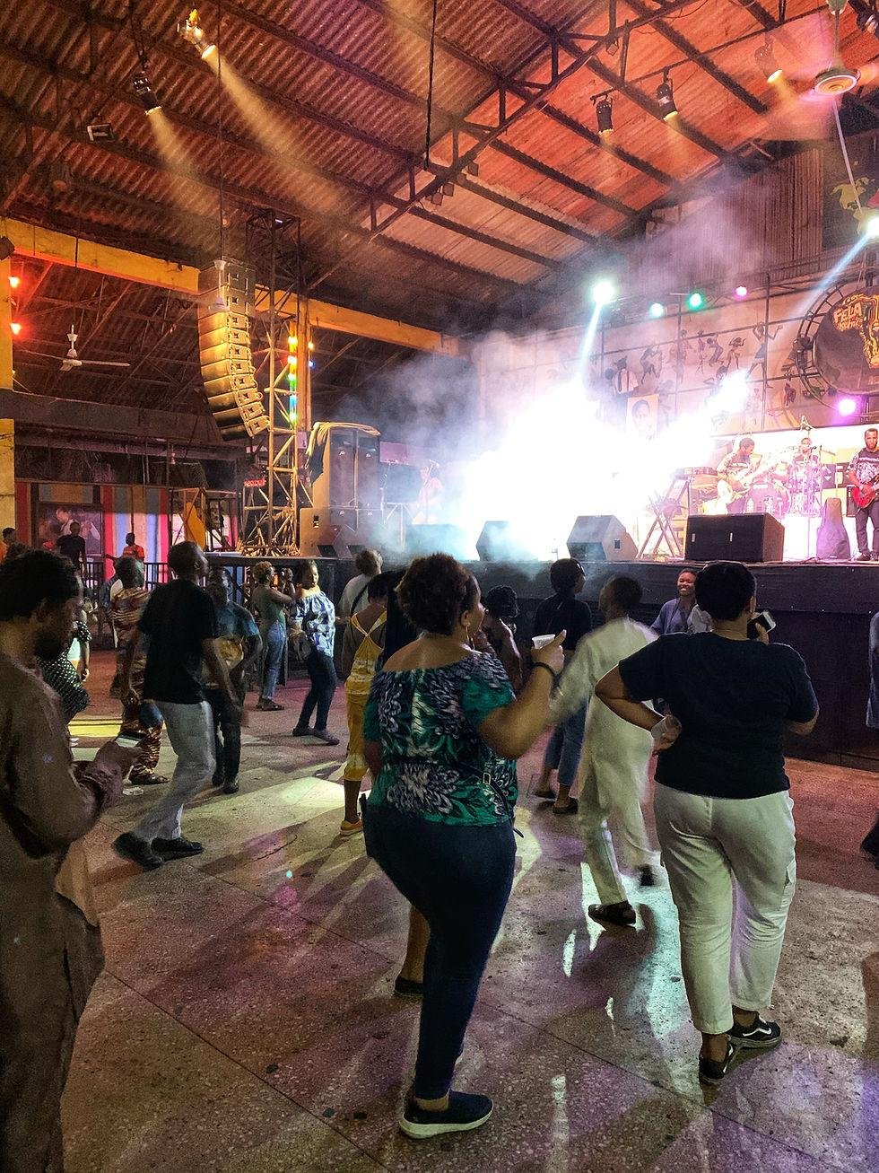Alt text: Musicians performing Afrobeat before a lively crowd at the New Afrika Shrine in Lagos.