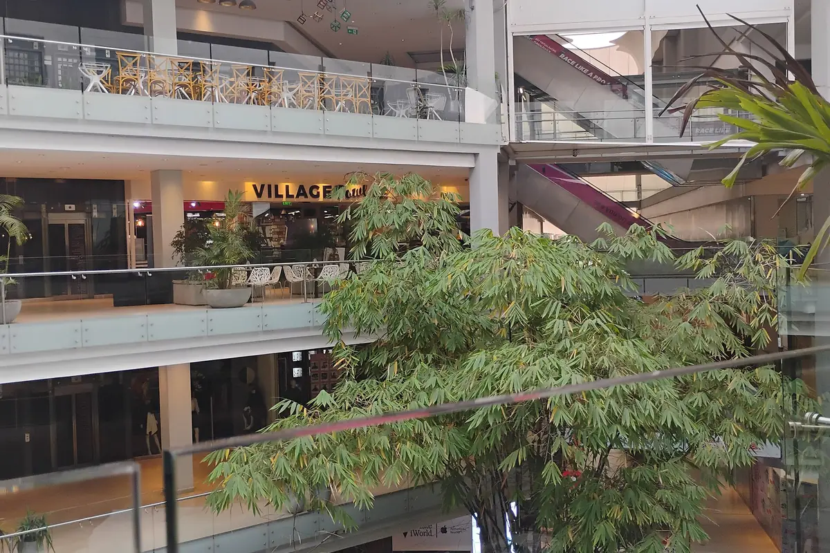 Multi-level interior with restaurants and greenery inside Village Market in Nairobi.